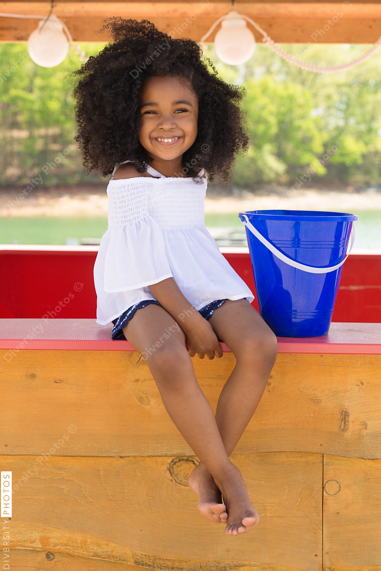 Smiling girl sitting at poolside