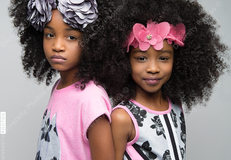 Portrait of girls posing against white background