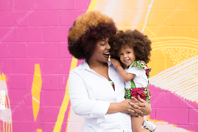 Smiling mother holding daughter