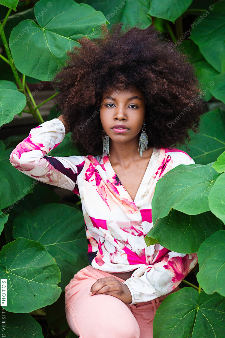 Portrait of young woman in foliage