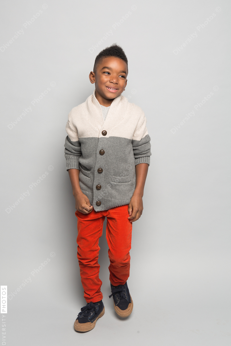 Smiling boy posing against white background