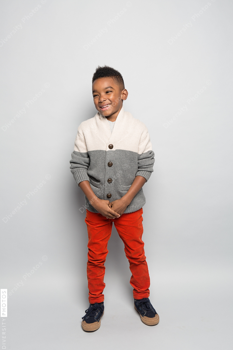 Smiling boy standing against white background