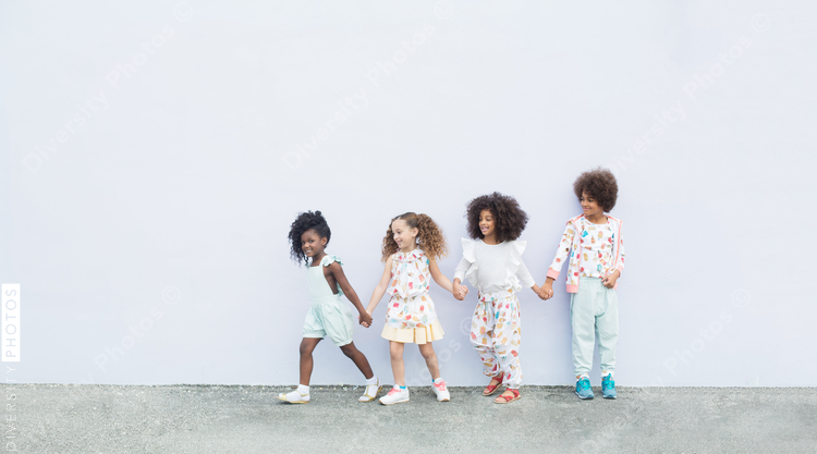 Happy children playing  against wall