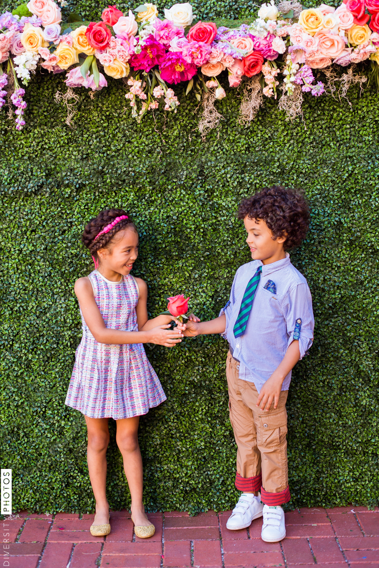 Happy boy and girl holding rose at outdoors