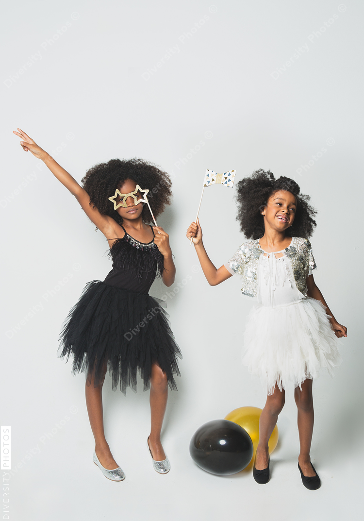 Playful girls standing against white background