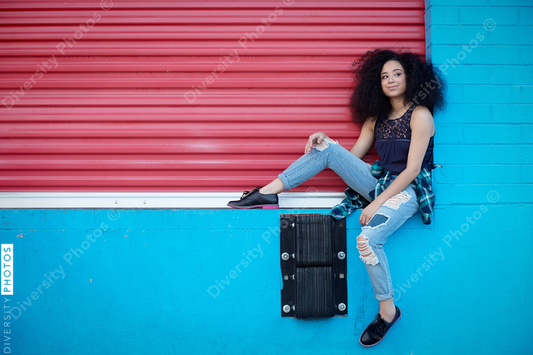 Young woman posing against wall