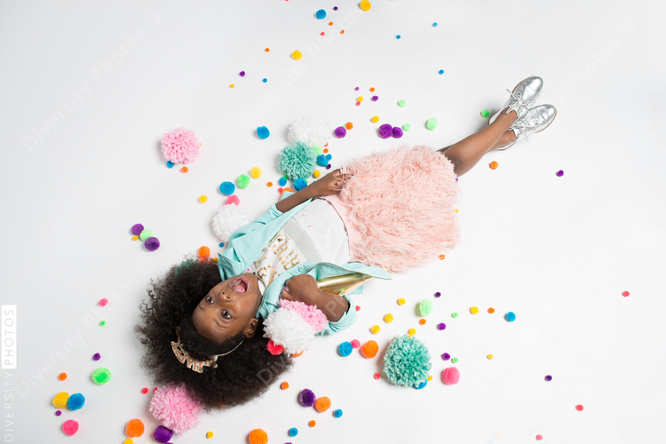 Overhead view of girl lying on white background