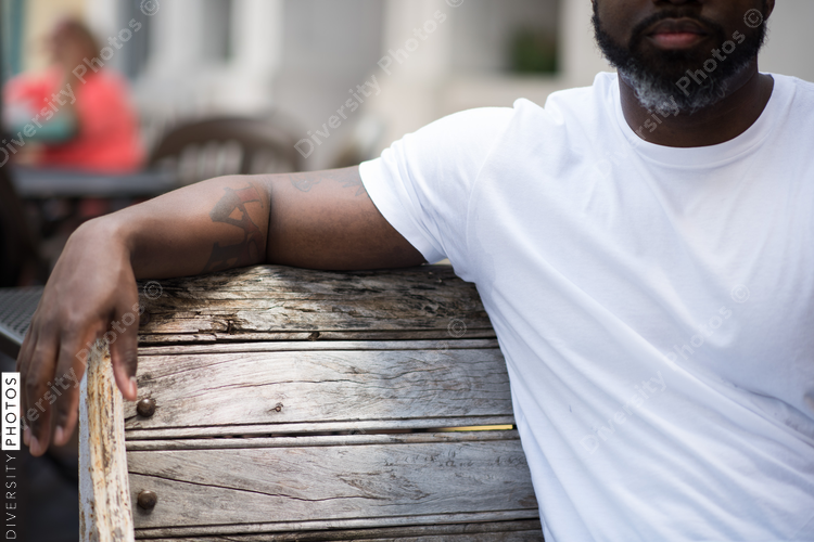 Mid section of man sitting on bench