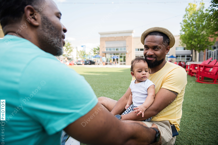 Couple looking at each other with baby in lap