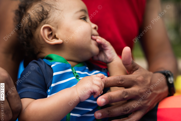 Man holding baby hand