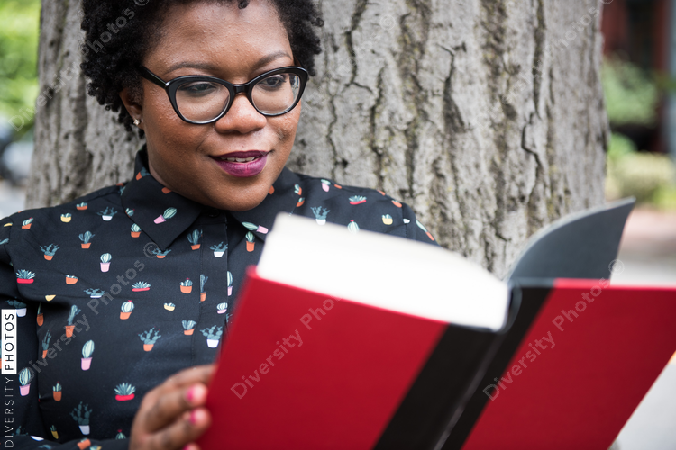 Close up of woman reading book outdoors