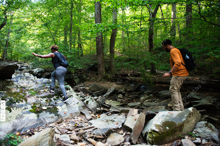 People crossing over rocks