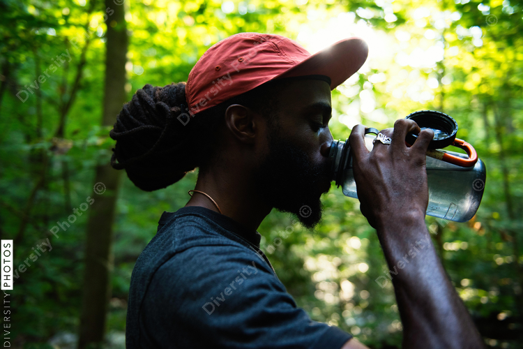 Man takes water break on nature trail