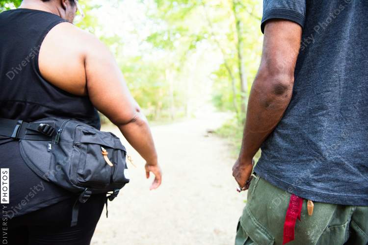 Black Woman and man walking nature trail 
