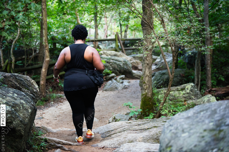 Woman walking up mountain nature trail