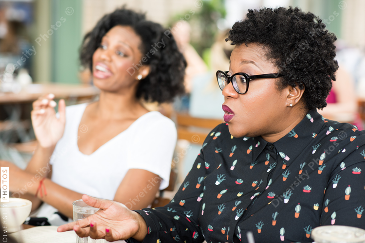 Businesswomen talking with colleagues in casual meeting