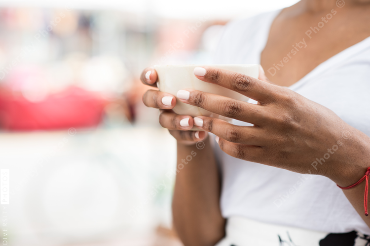 Mid section of woman holding coffee cup