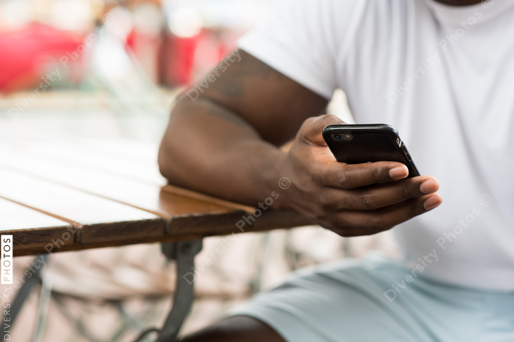Mid section of man using smartphone