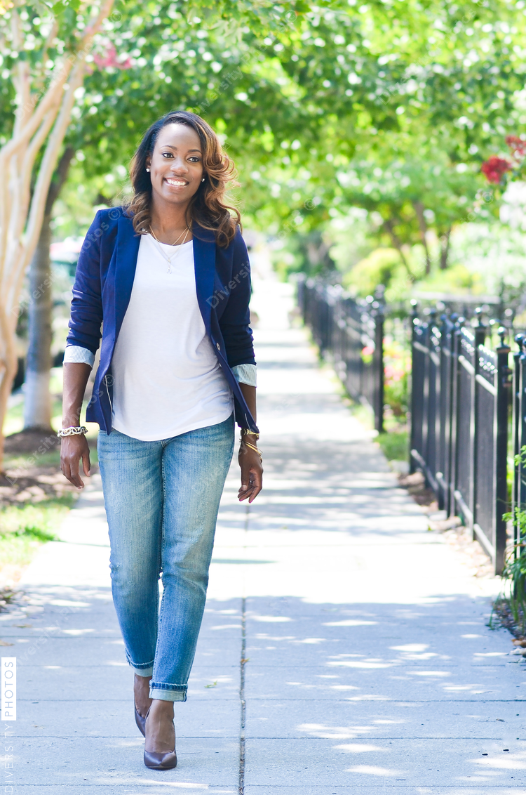 Smiling young woman walking on sidewalk