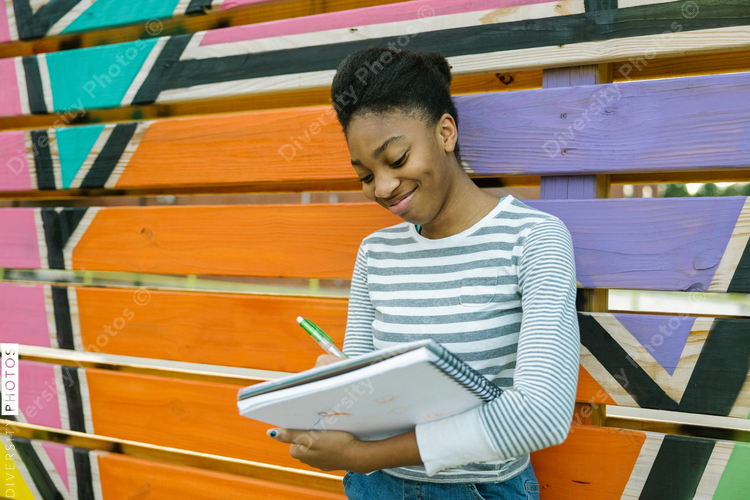 Young Black teen female studying art at school