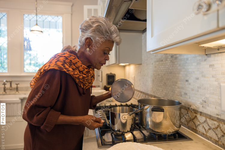 Black senior woman cooking in kitchen