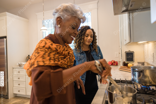 Black mother and daughter cooking in the kitchen