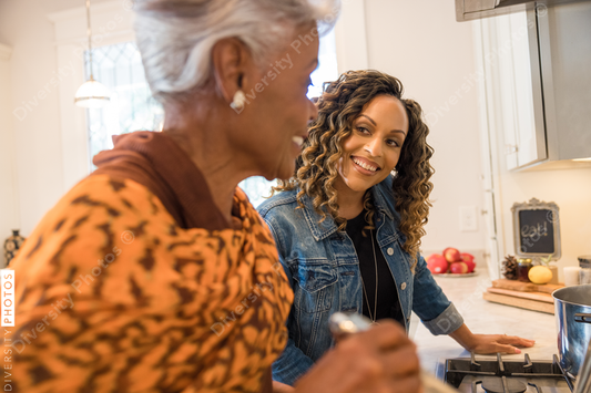 Black mother and daughter cooking in the kitchen
