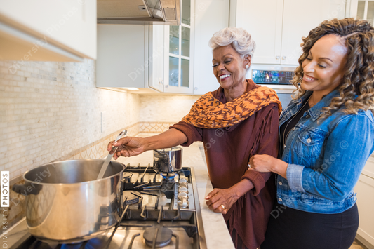 Black mother and daughter cooking in the kitchen