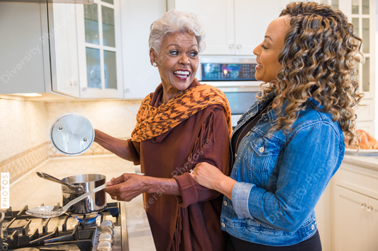 Black mother and daughter cooking in the kitchen