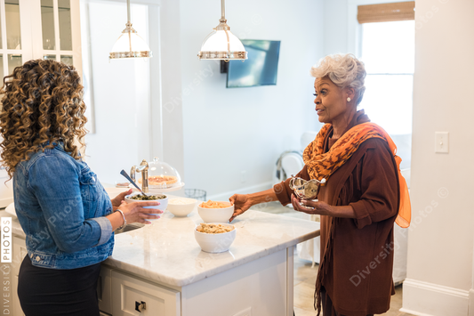 Black mother and daughter cooking in the kitchen