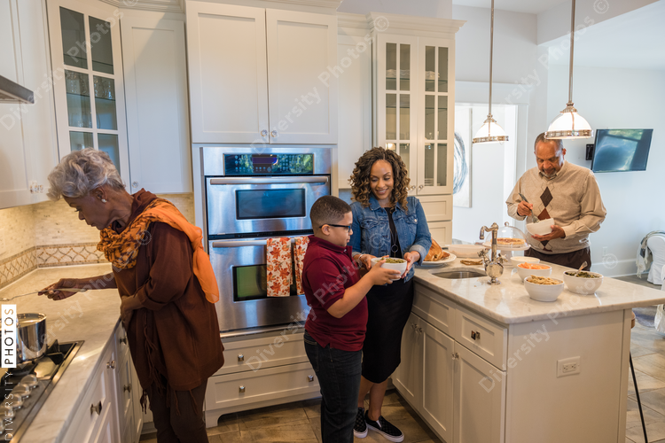 Family prepares Thanksgiving food in kitchen