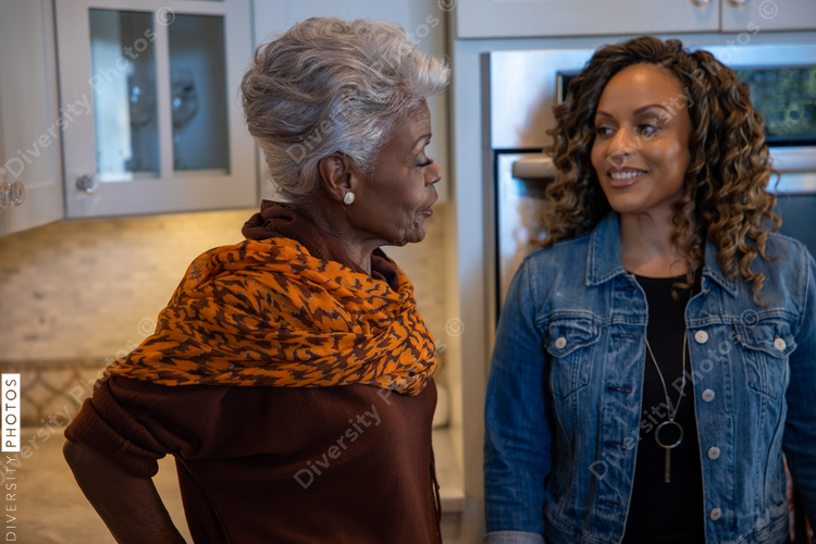 Black mother and daughter cooking in the kitchen