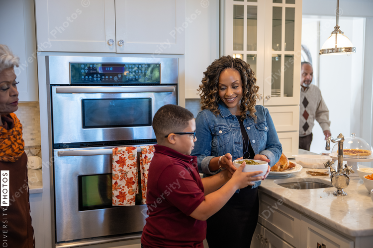 Family prepares Thanksgiving food in kitchen