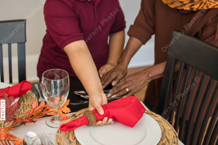 Grandmother and grandson doing Thanksgiving dinner setting