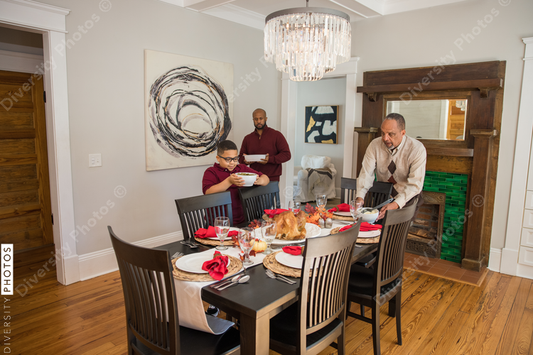 Black multigenerational men setting table for Thanksgiving  holiday meal
