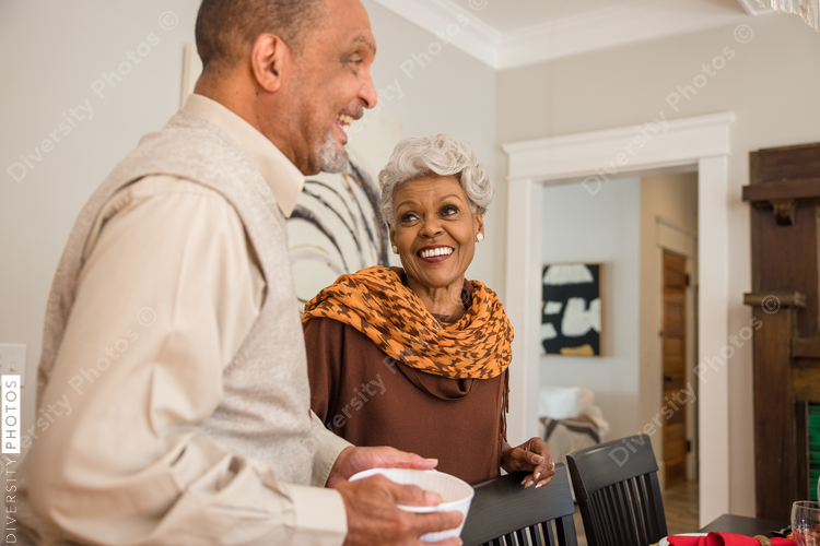 Grandparents laughing at Thanksgiving dinner