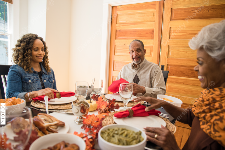 Black multigenerational family eating Thanksgiving holiday meal