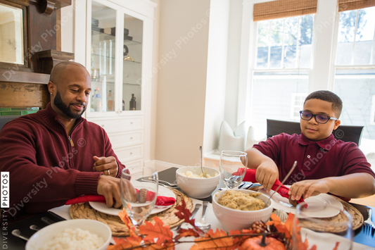 Black multigenerational family eating Thanksgiving holiday meal