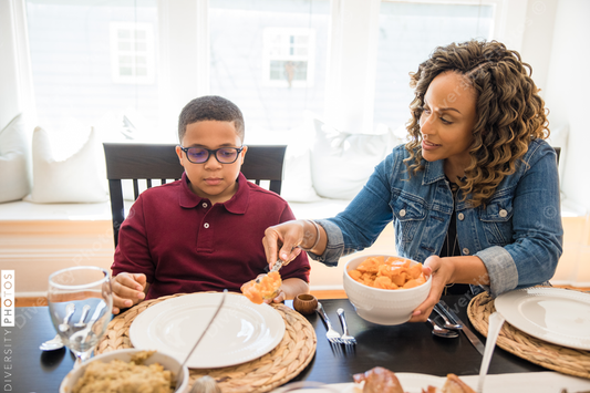 Black multigenerational family eating Thanksgiving holiday meal