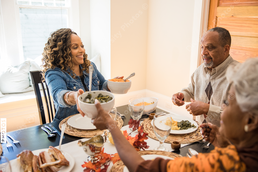 Black multigenerational family eating Thanksgiving holiday meal