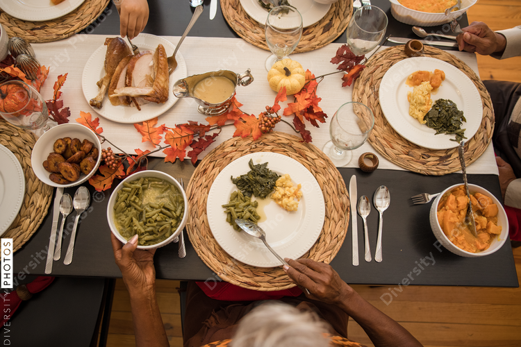 Overhead view of black hands eating Thanksgiving holiday meal
