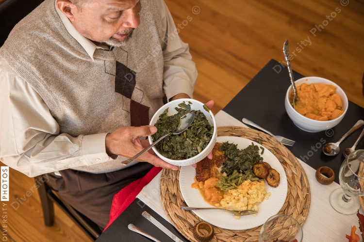 Overhead view of black hands eating Thanksgiving holiday meal