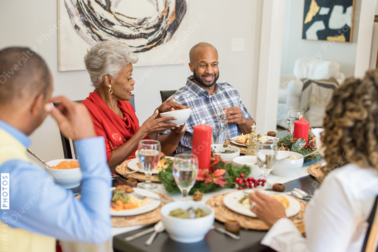 Black family eating Christmas dinner together at dining room table