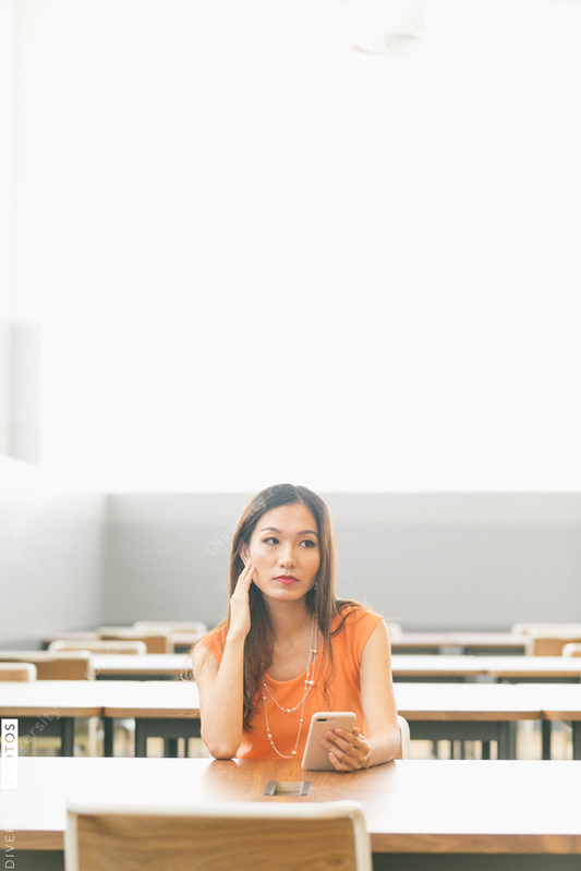 Young woman using cell phone indoors