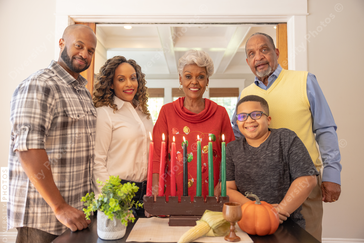 Multigenerational black family celebrating Kwanzaa together