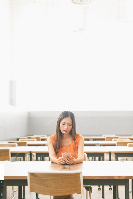 Young woman using cell phone indoors