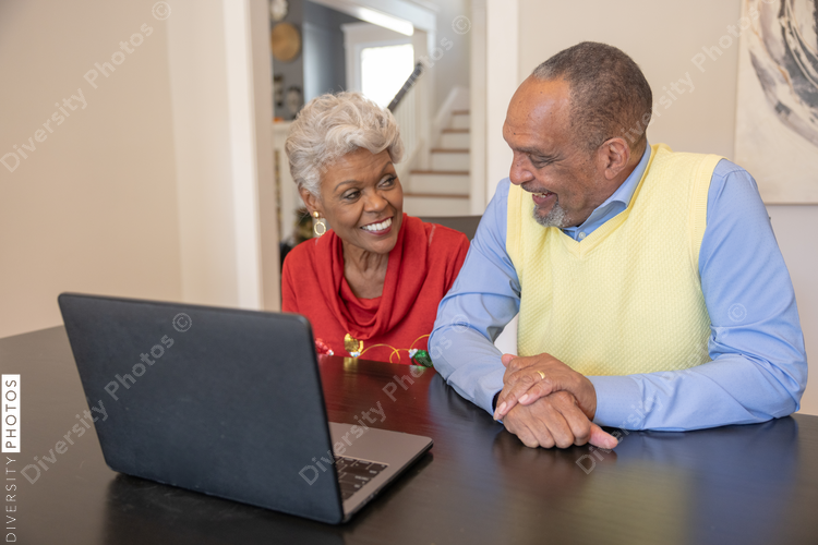 Grandmother and grandfather having a video chat on laptop at home for Christmas