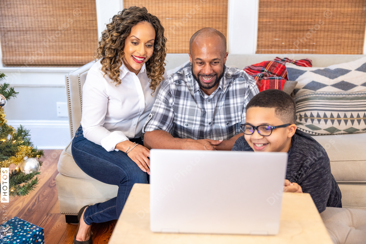 Family having a video chat  with grandparents on laptop at home for Christmas