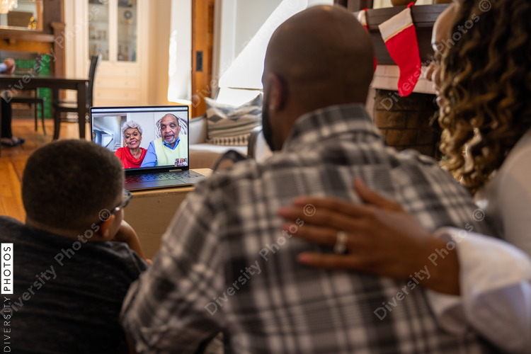 Family having a video chat  with grandparents on laptop at home for Christmas