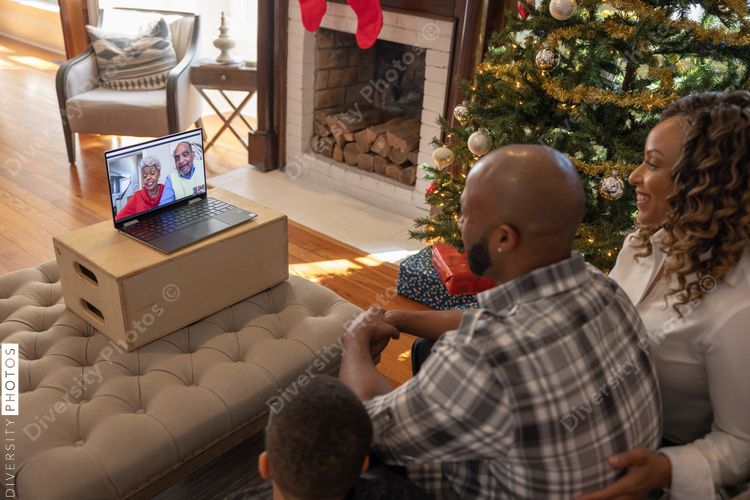 Family having a video chat  with grandparents on laptop at home for Christmas